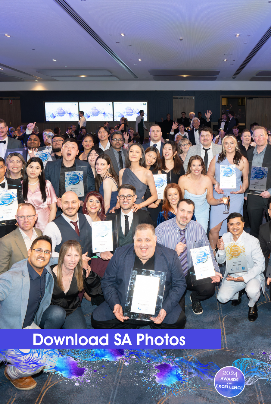 Image of a group of people at an awards ceremony, with trophies and certificates displayed, highlighting the recognition and achievements in the hospitality industry.