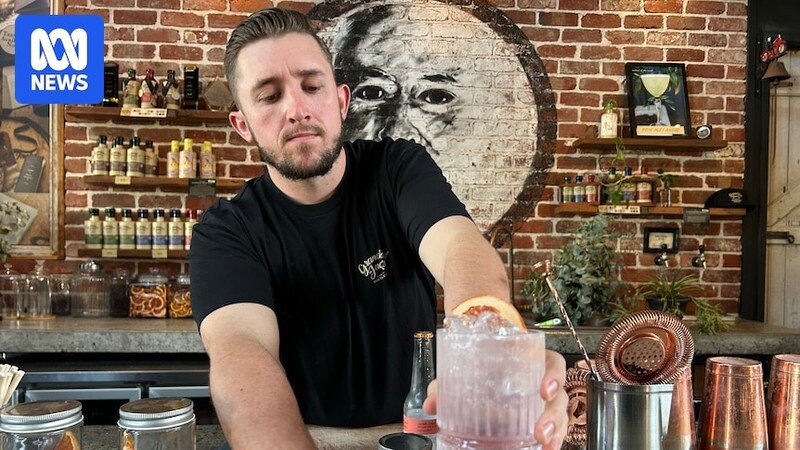 Bartender handing over a drink at the bar