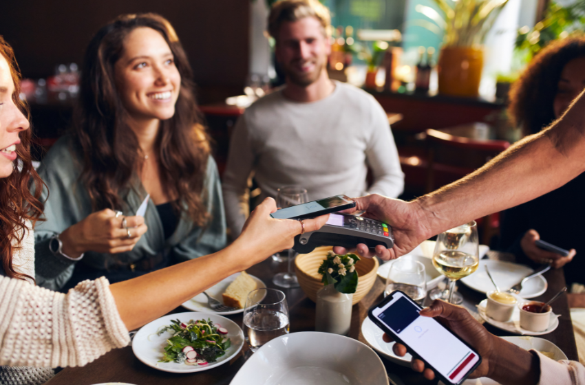 happy customers paying for their meals in restaurant by card