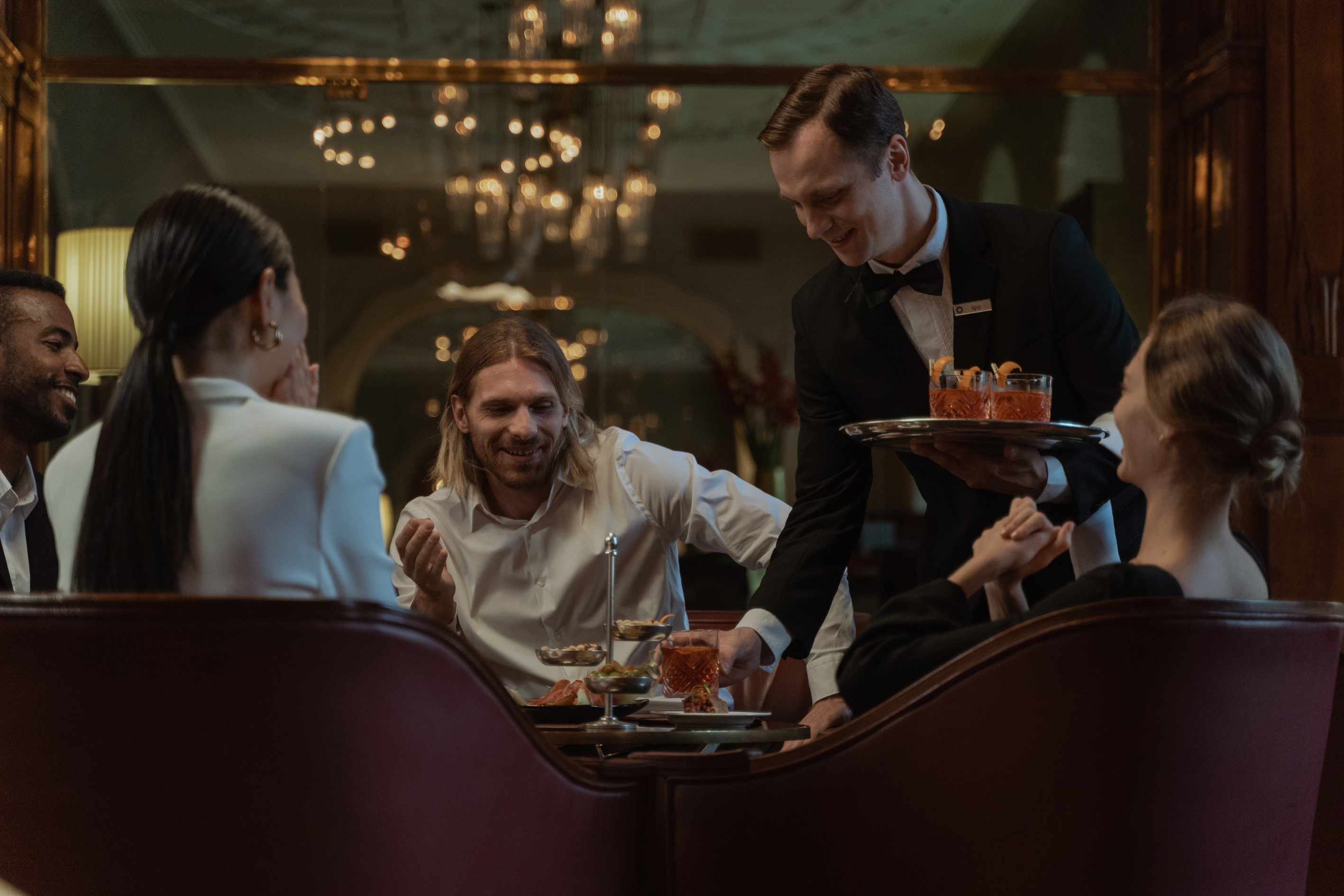 Waiter serving customers at the restaurant