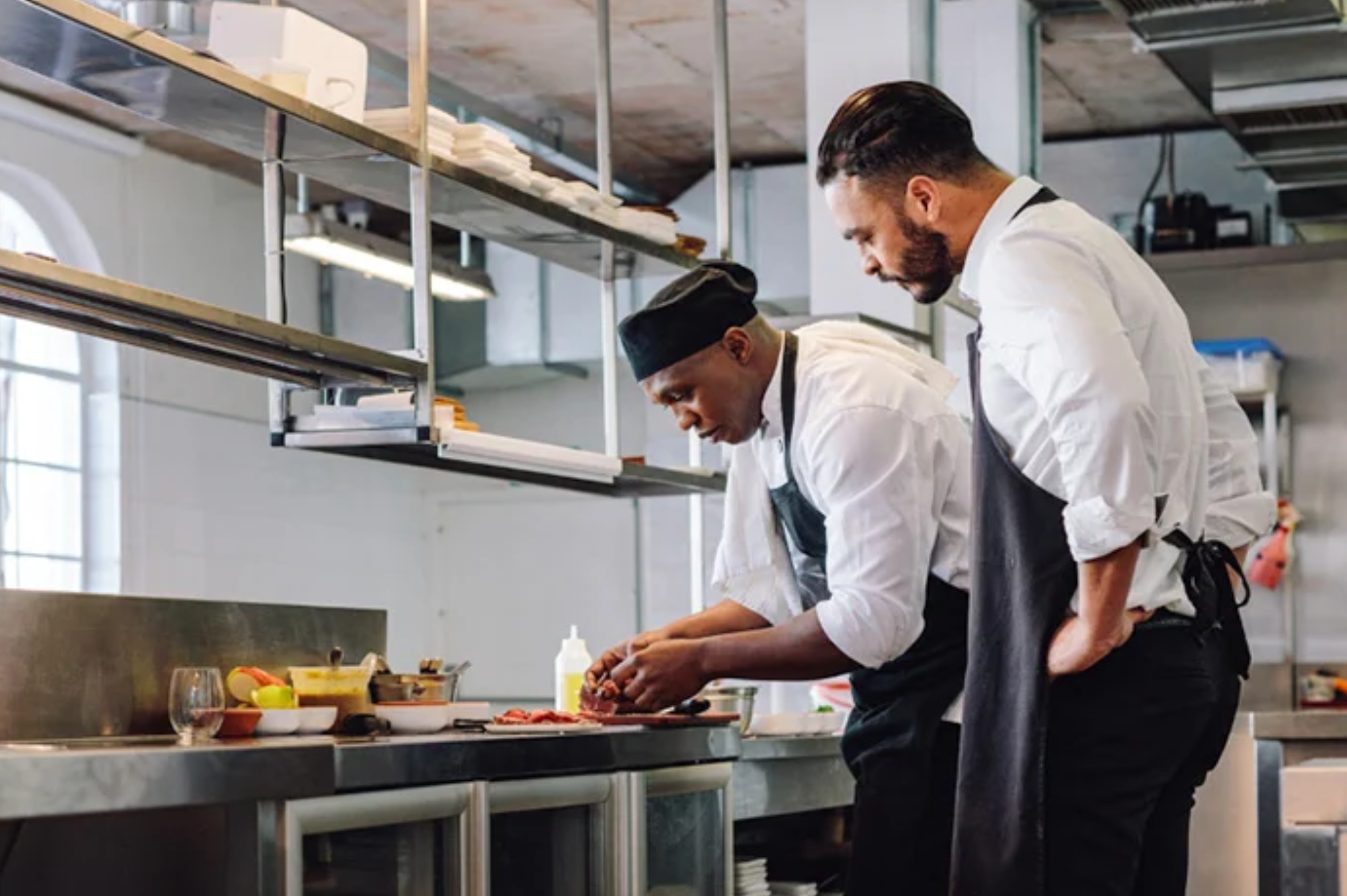 Image of a chef in a professional kitchen, emphasizing the importance of food safety training for Food Safety Supervisors.